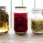 three jars filled with different types of food